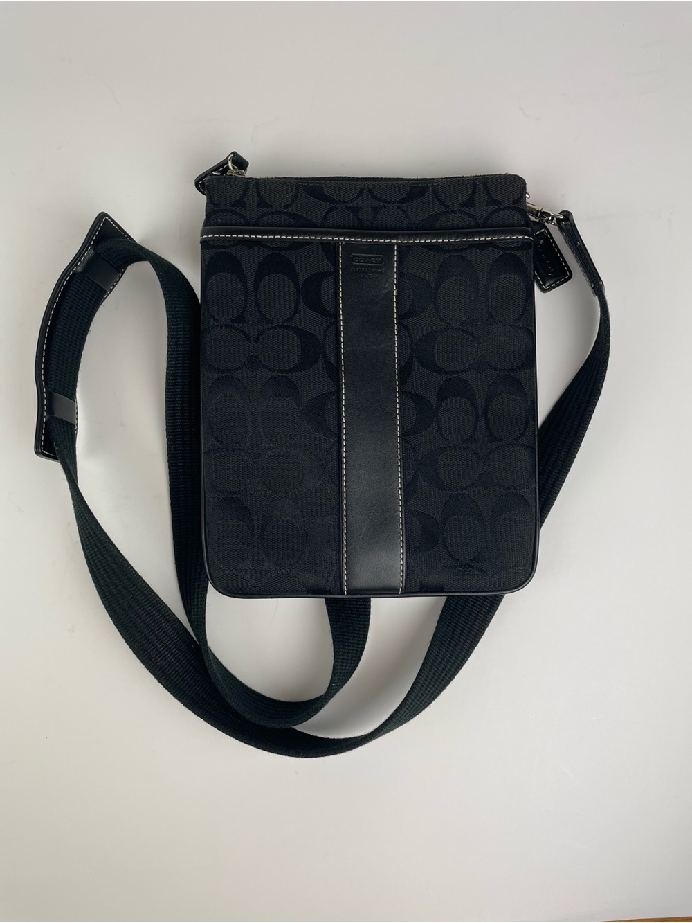 Coach black canvas crossbody bag with repeating C logo pattern